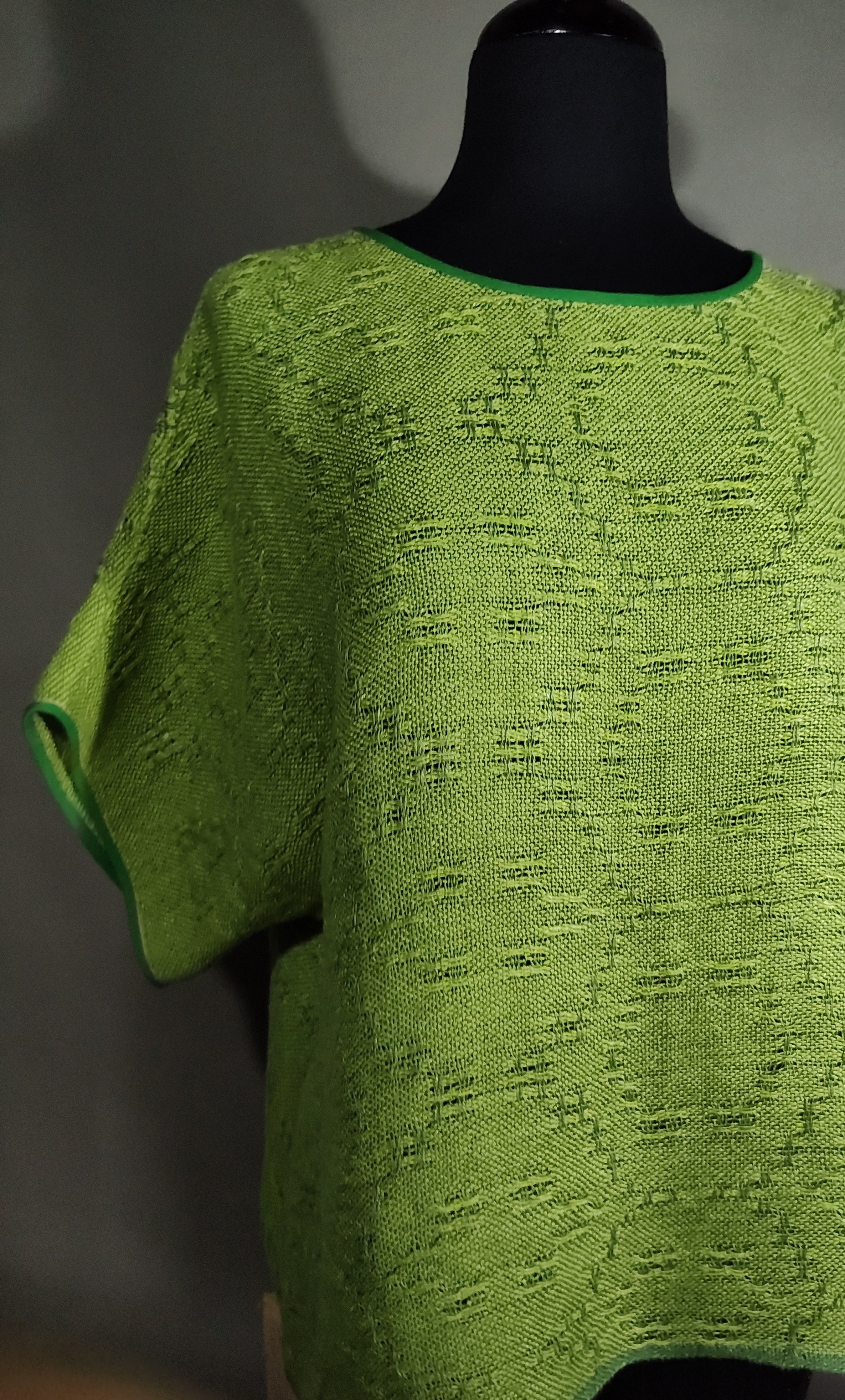 Photo os a pale green handwoven linen short on a mannequin