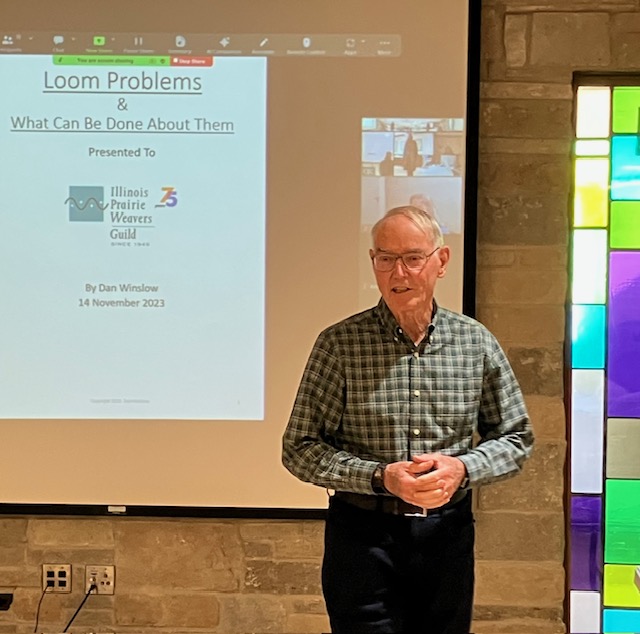 Man standing in front of a projection screen with a slide displayed