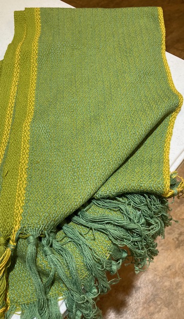 Fringed tools woven in green with yellow border accents.