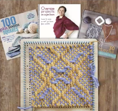 A large pin loom with a weaving in shades of light blue and yellow in the foreground, and three spiral-bound pin loom weaving books in the background