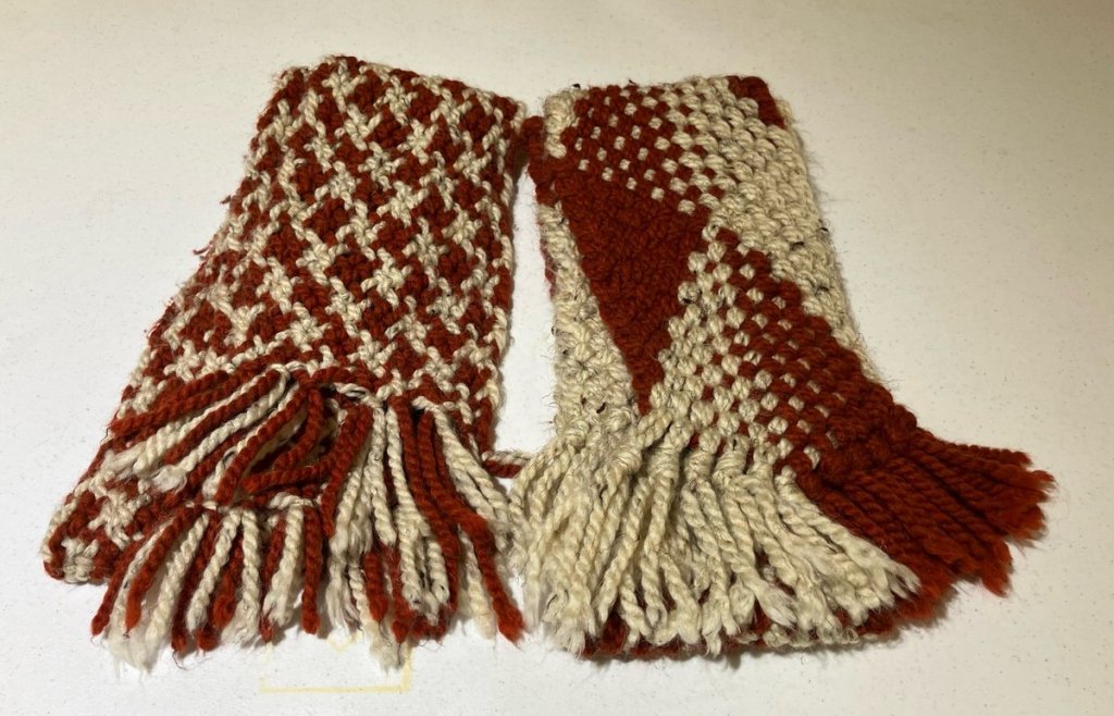 Two finger-woven fringed scarves in shades of deep red and tan
