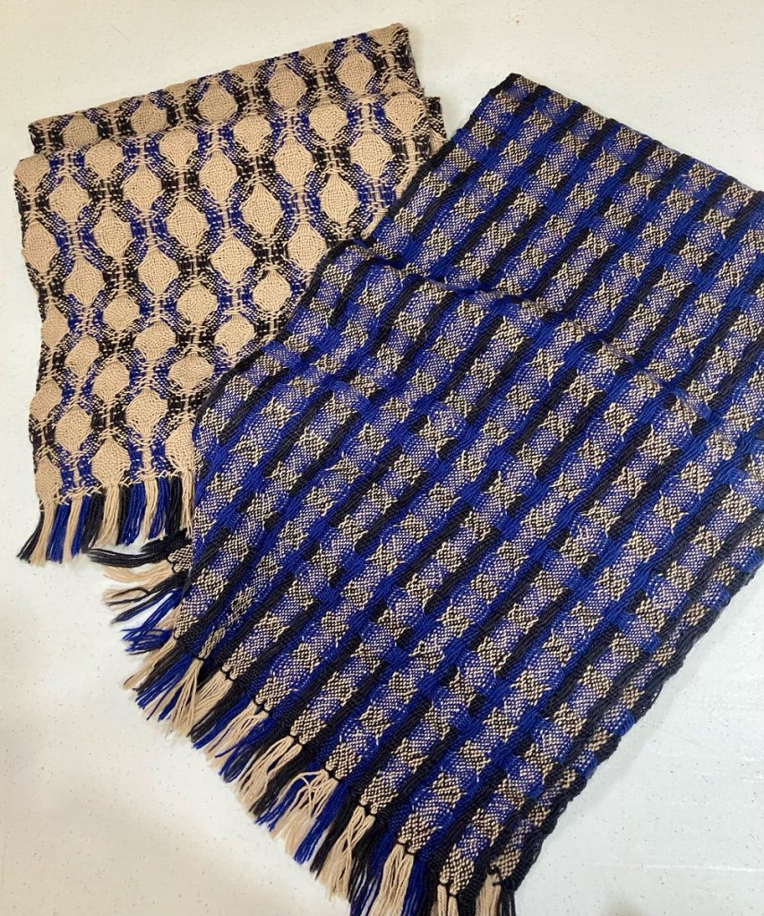 Two deflected double weave scarves in beige, blue, and navy.