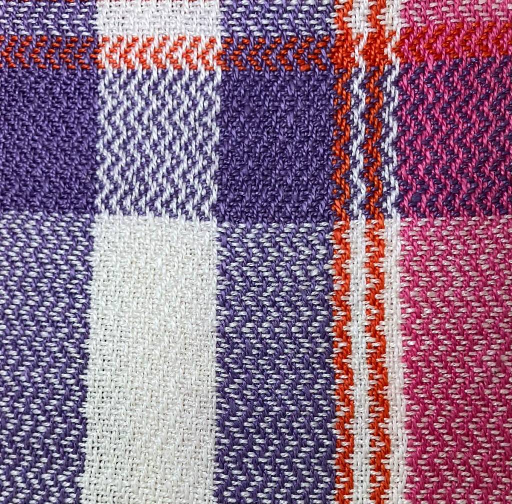 Close up of table runner, white, blue, red and pink twill stripes.