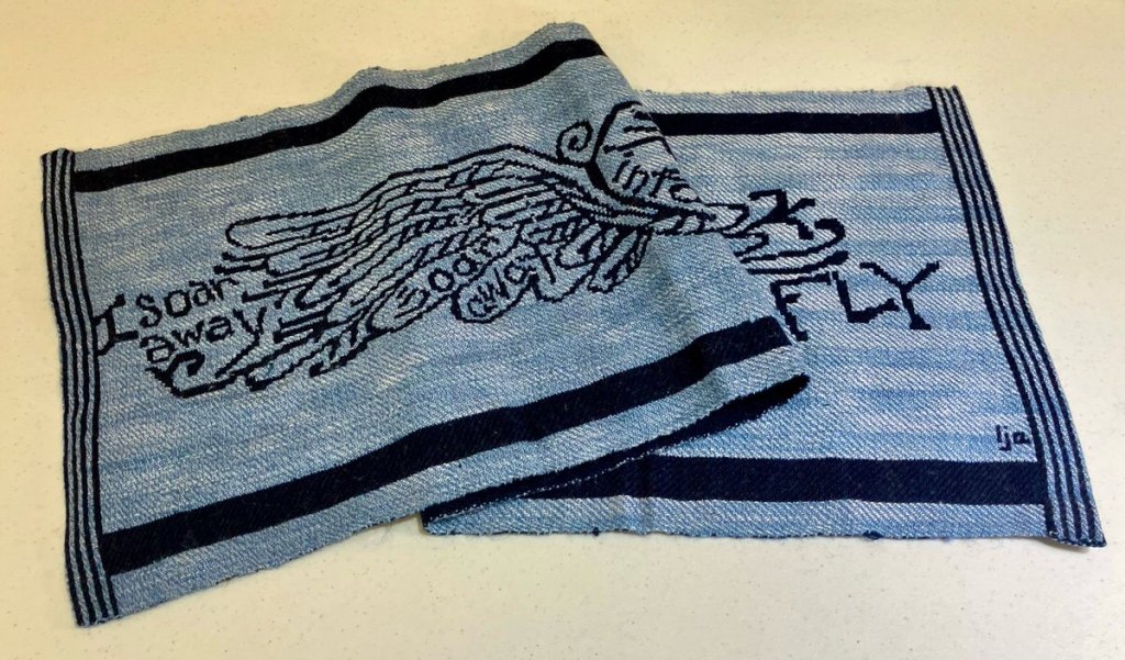 Blues of various shades, double weave pickup that says "I soar away" with a picture of wings.