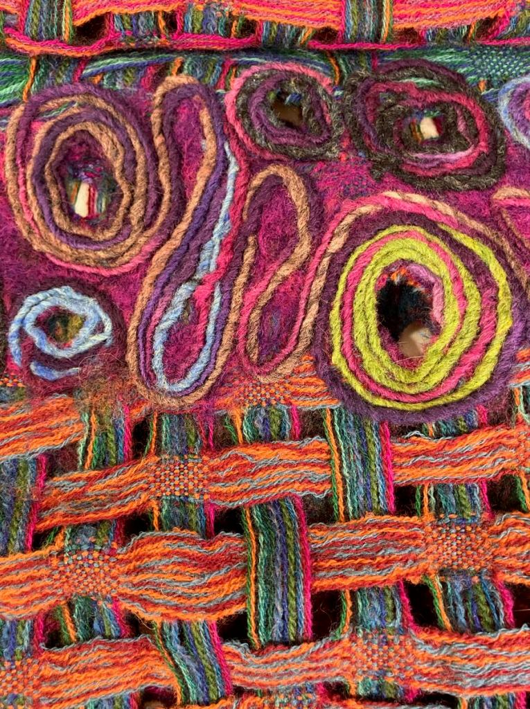 Detail of Tammy D.'s poncho showing the wet felted segments and the weaving.