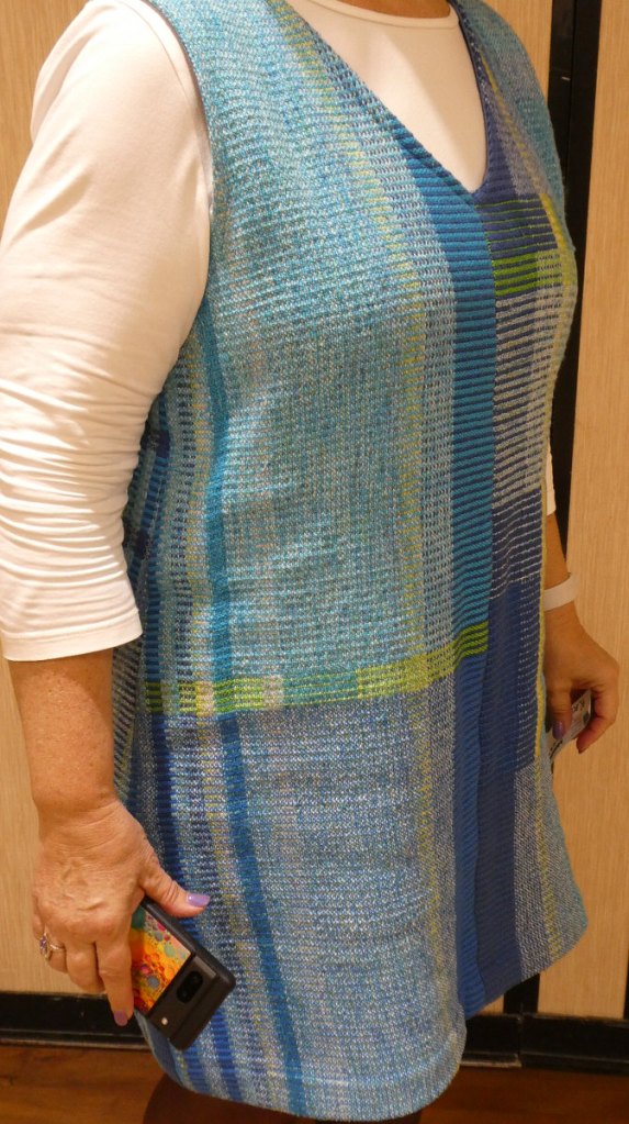 Kathy A., jumper. Right side view of a woman wearing a blue and yellow striped jumper.