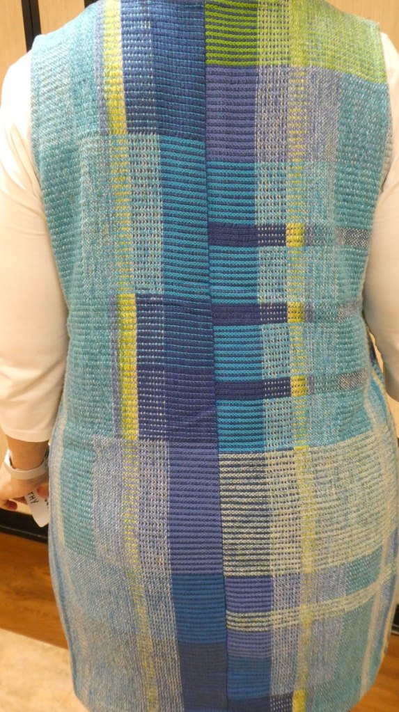 Kathy A., jumper. Back view of a woman wearing a blue and yellow striped jumper.