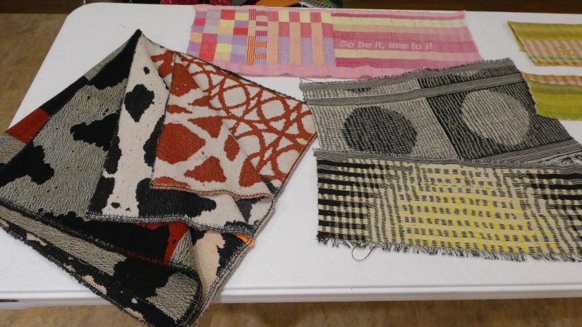 Several colorful woven samples featuring intricate shapes