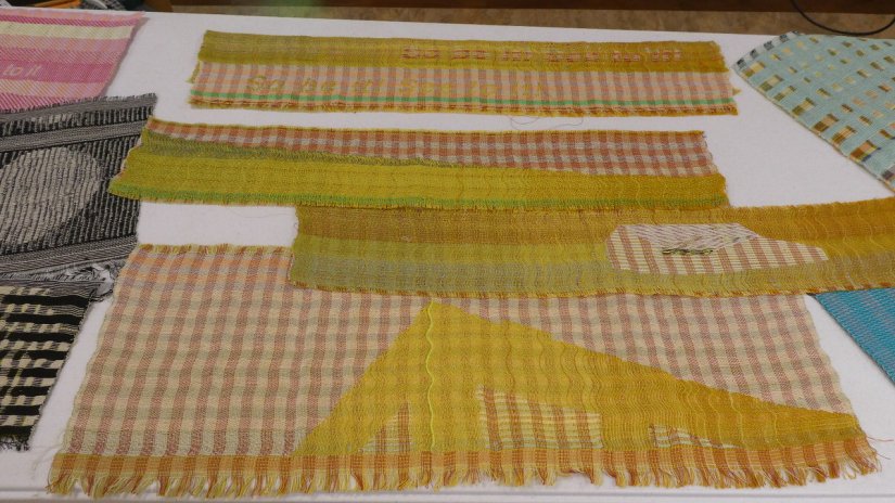 Several colorful woven samples featuring intricate shapes