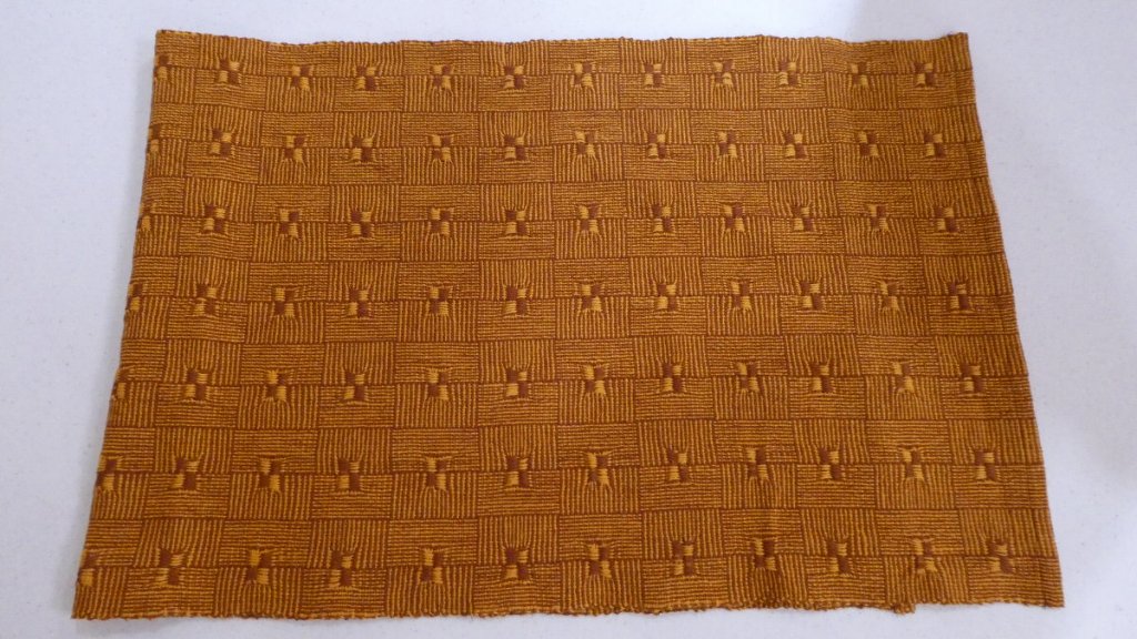 Tam M., gold and brown squares surrounding 2x2 long threads as smaller squares.