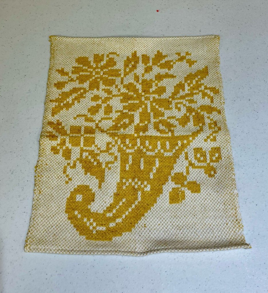 Yellow cornucopia with flowers at the top on a white background.