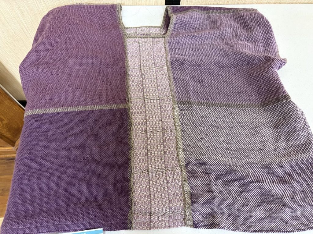 Shirt woven in shades of lavender, cream, light green with sections woven using different weave structures and shades