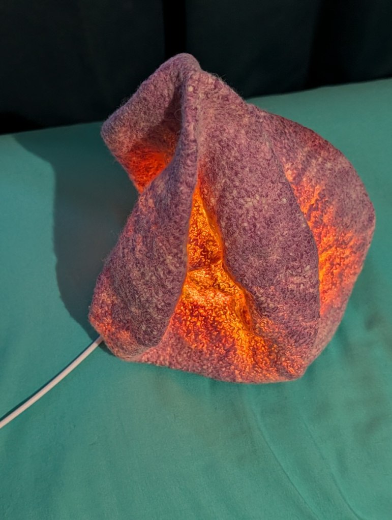 Luminary 4. Lit. Almost cone shaped with a variety of textures.