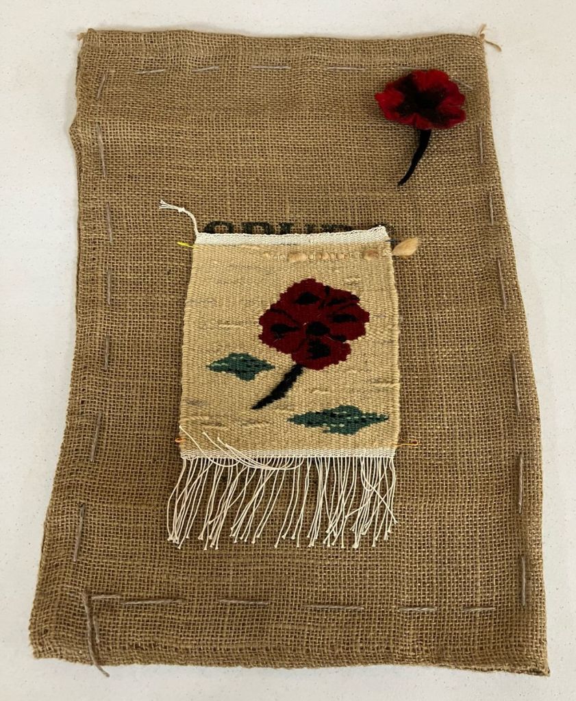 Red flower pin and a red flower tapestry.