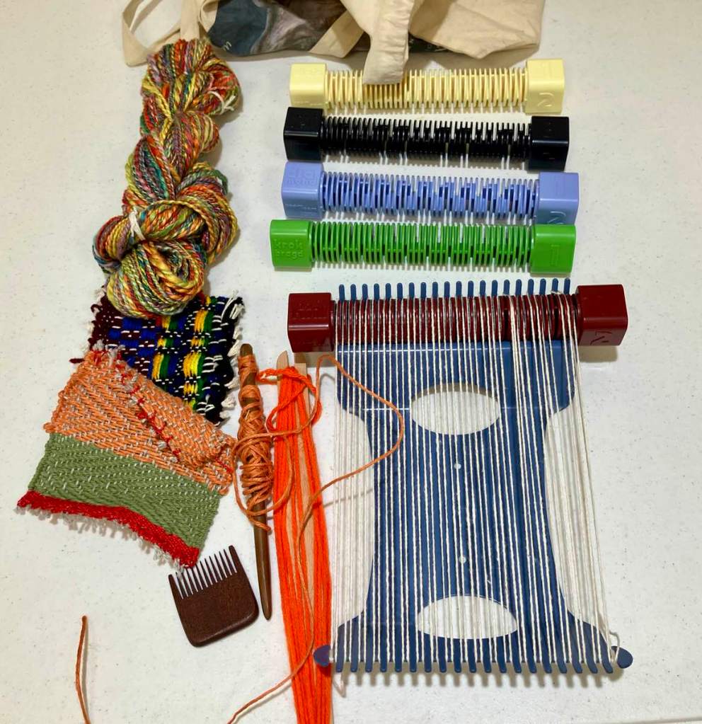 Hal W. - A skein of multi-colored hand spun yarn, some tools, two samples, and a Boomloom.