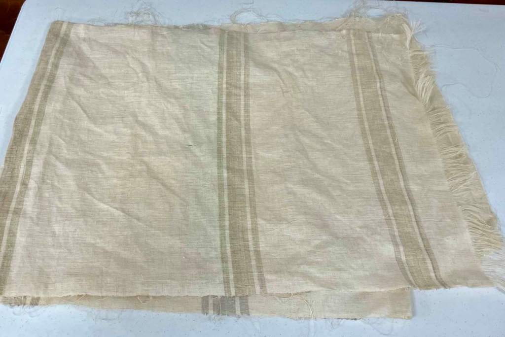 Sarah B. - Off white linen fabric with brown stripes that will be used a pillowcase.
