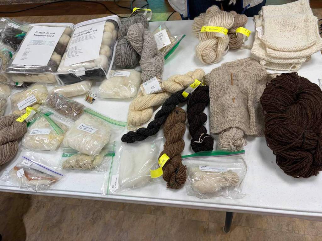 Various forms and colors of wool resting on a table.