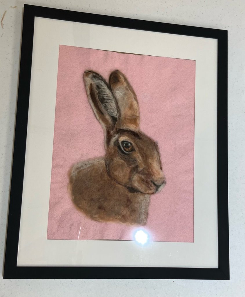 Framed picture of the head and upper body of a brown hare.