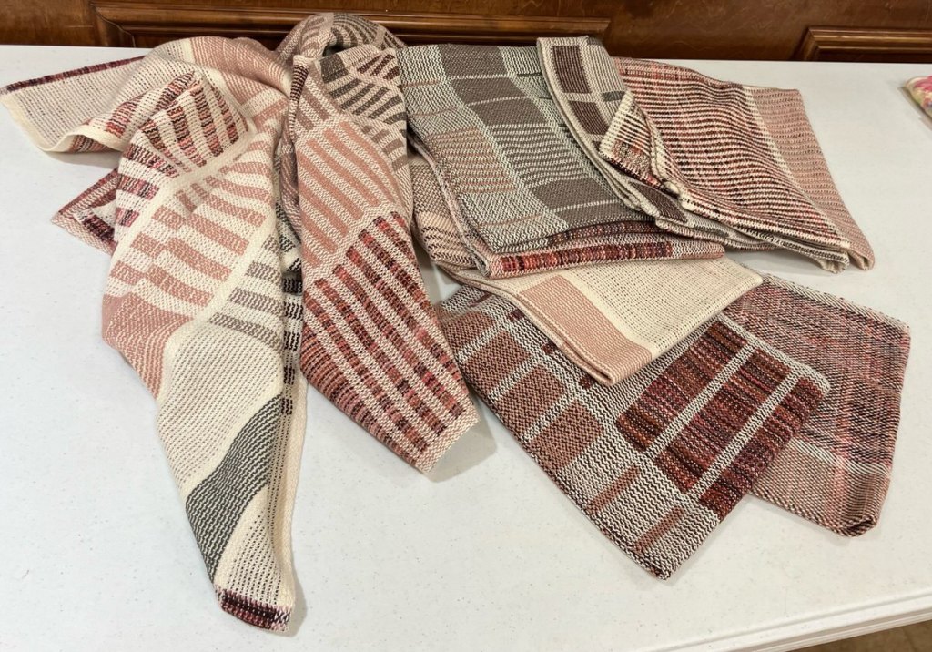Striped towels in reds, grays, browns, and rust.
