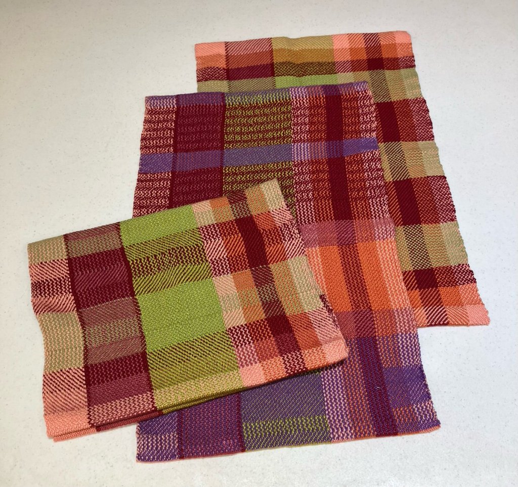 Multicolored lengths of striped handwoven fabric.