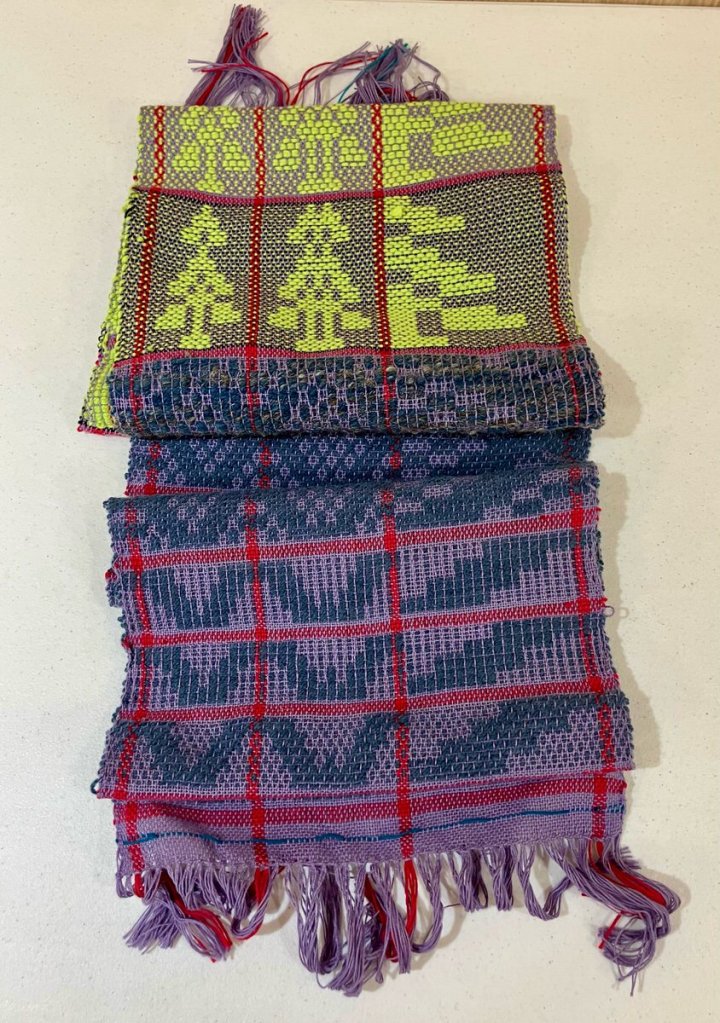 Betty K. - Overshot sampler using blue, yellow, purple with thing red lines separating the blocks in both directions.