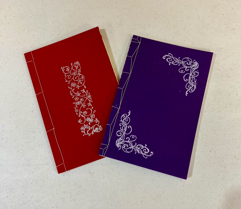 Diane W. - Dark red and purple handmade books.
