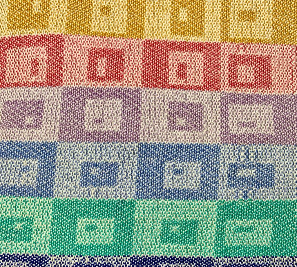 Linda A. - Rows of squares with smaller squares inset with smaller squares. The squares alternate internally with dark and light versions of the same color for each row.
