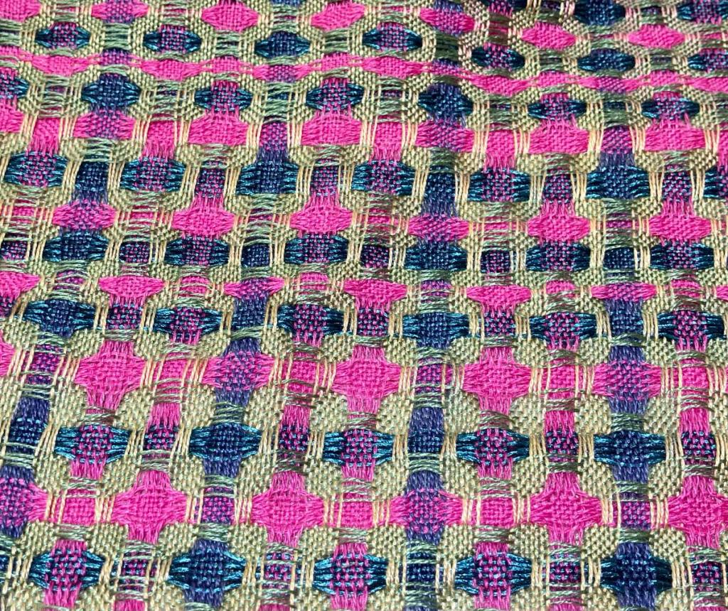 Closeup of Tammy D.'s project. Dark blue, pinkish purple, and olive green stripes crossing each other in both directions.