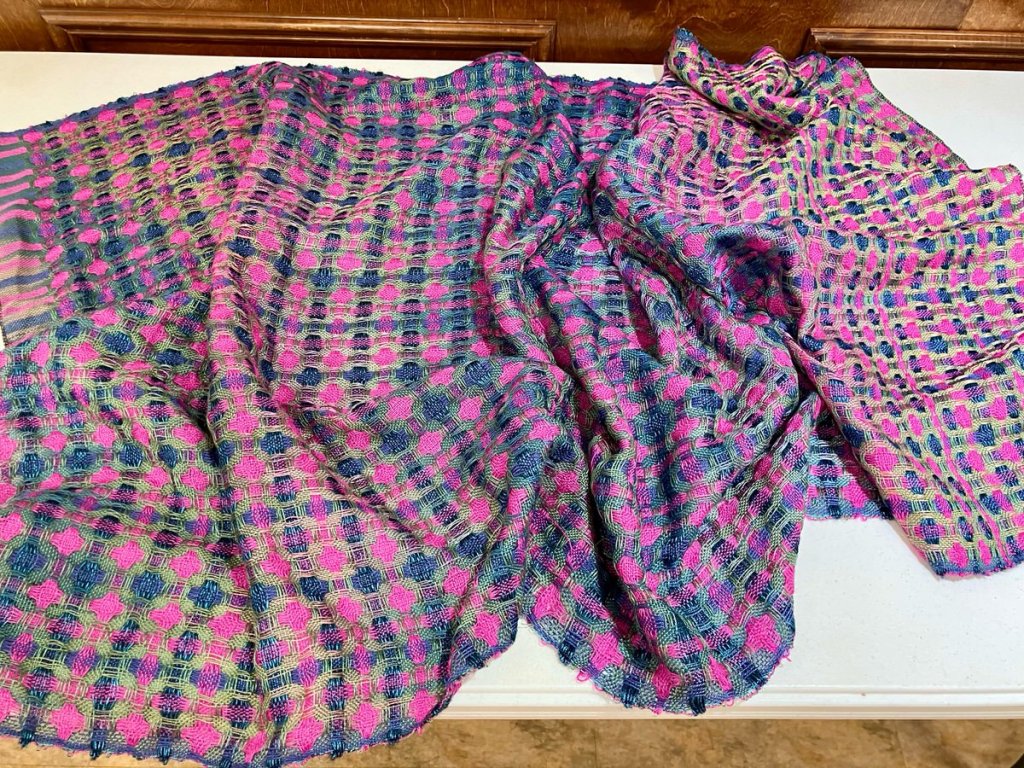 Tammy D. - Full piece of cloth. Dark blue, pinkish purple, and olive green stripes crossing each other in both directions.