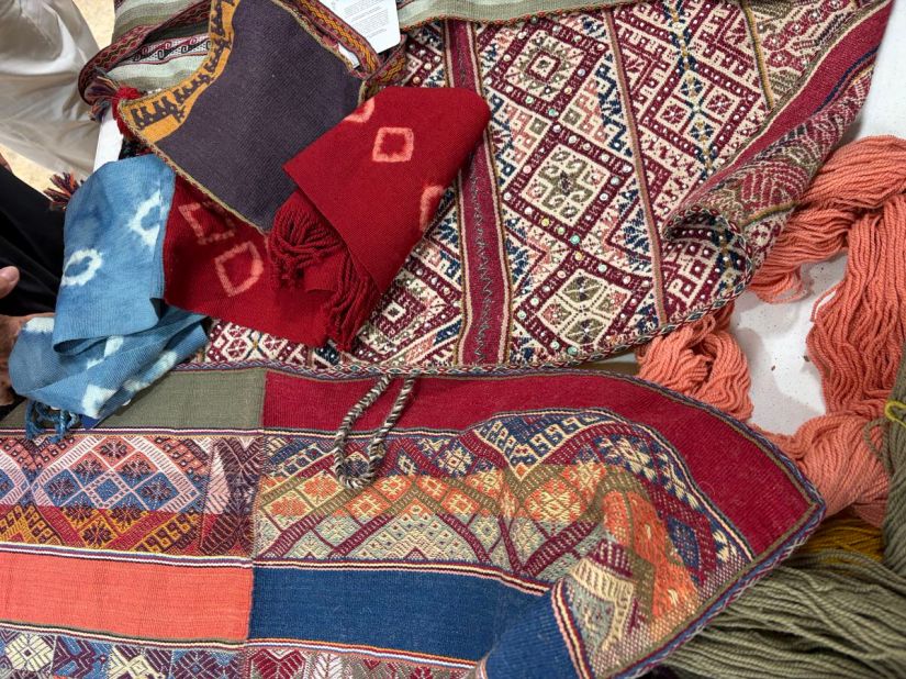 Several woven and resist-dyed fabrics on a table