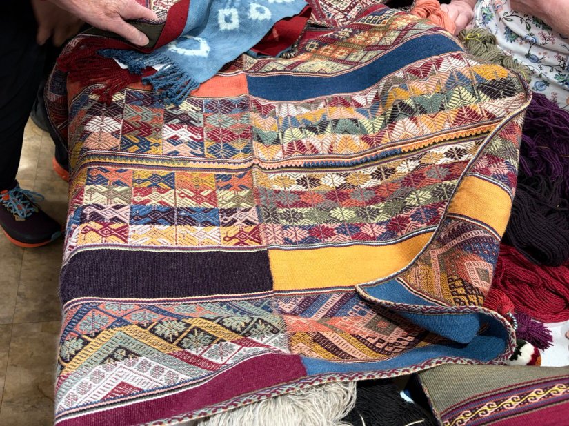 An intricately patterned piece of cloth that is actually multiple pieces of handwoven fabric combined into one.
