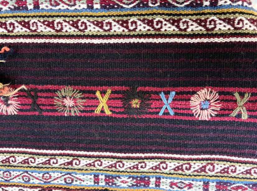 Close-up of hand embroidery along a seam.